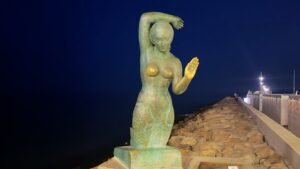Sitges brass mermaid at night